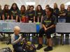 Liam Craane, 5, left, who is battling pediatric cancer, opens presents given to him by the John Jay field hockey team. Liam was "adopted" by the team through a program created by the Friends of Jaclyn Foundation. Sitting at left is field hockey coach and physical education teacher Kristen Perry.