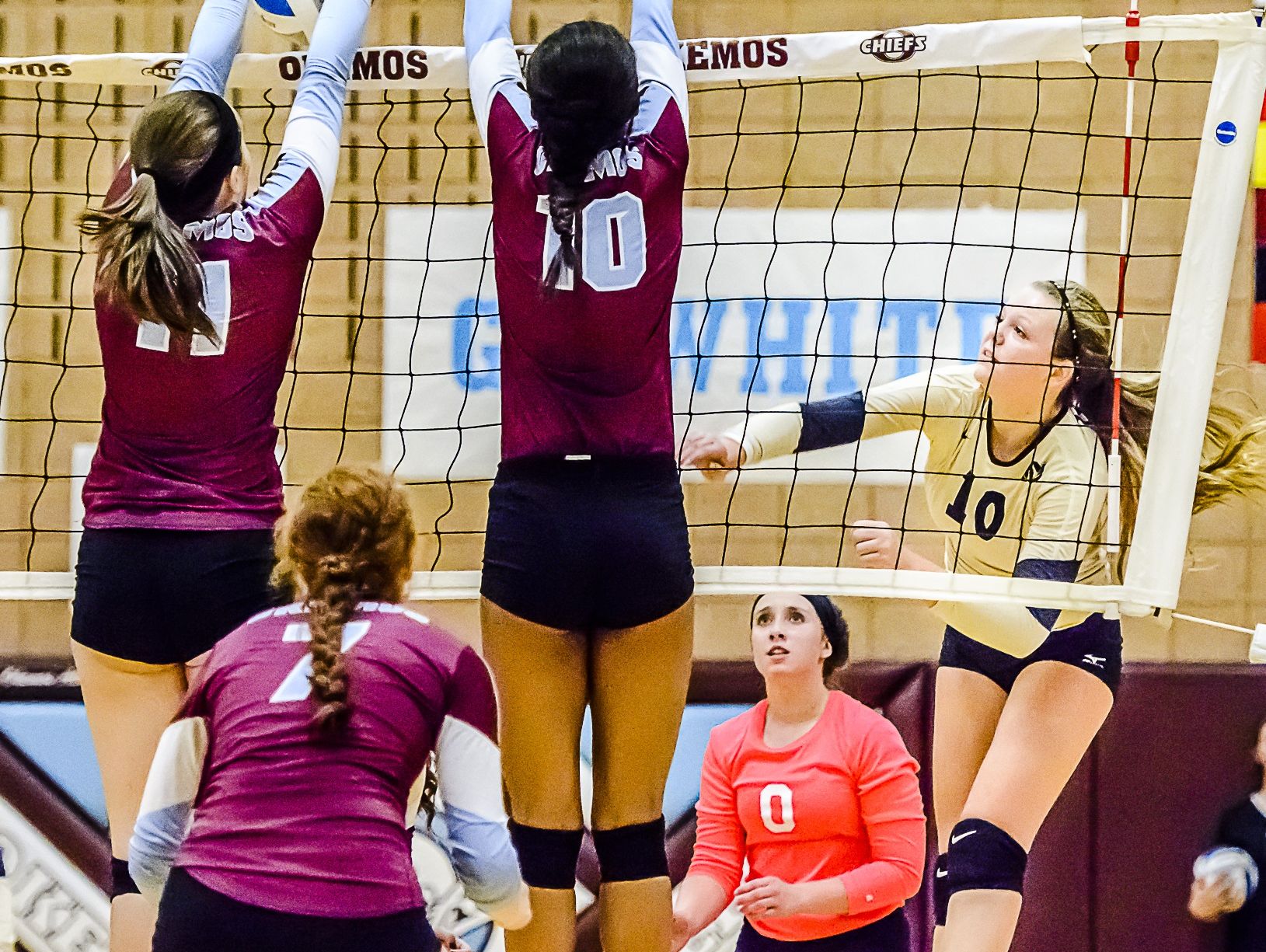 Breann DeLoye, left, of Okemos blocks a hit by Allie Peterson, right, of Holt early in the third game of their match in 2015.
