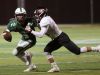 Brewster quarterback Jack Guida gets taken down by Rye's Peter Chabot during their game Friday night at Brewster High School. Guida and the Bears had the last laugh, though, stunning the Garnets 11-7.