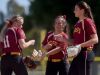 Roosevelt's Jasmine Schnider (left to right), Kylie Madrid and Lexi Koltz high five in-between batters against Rapid City Central at Sherman Park Softball Complex.