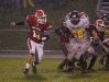Laingsburg quarterback Nick Putnam, left, runs on a keeper against Pewamo-Westphalia's Isaiah Schafer Friday, Sept. 30, 2016, in Laingsburg, Mich.