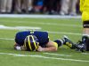 In this Sept. 27, 2014, photo, Michigan quarterback Shane Morris lays on the field after taking a hit. He was put back in the game and later determined to have a concussion.