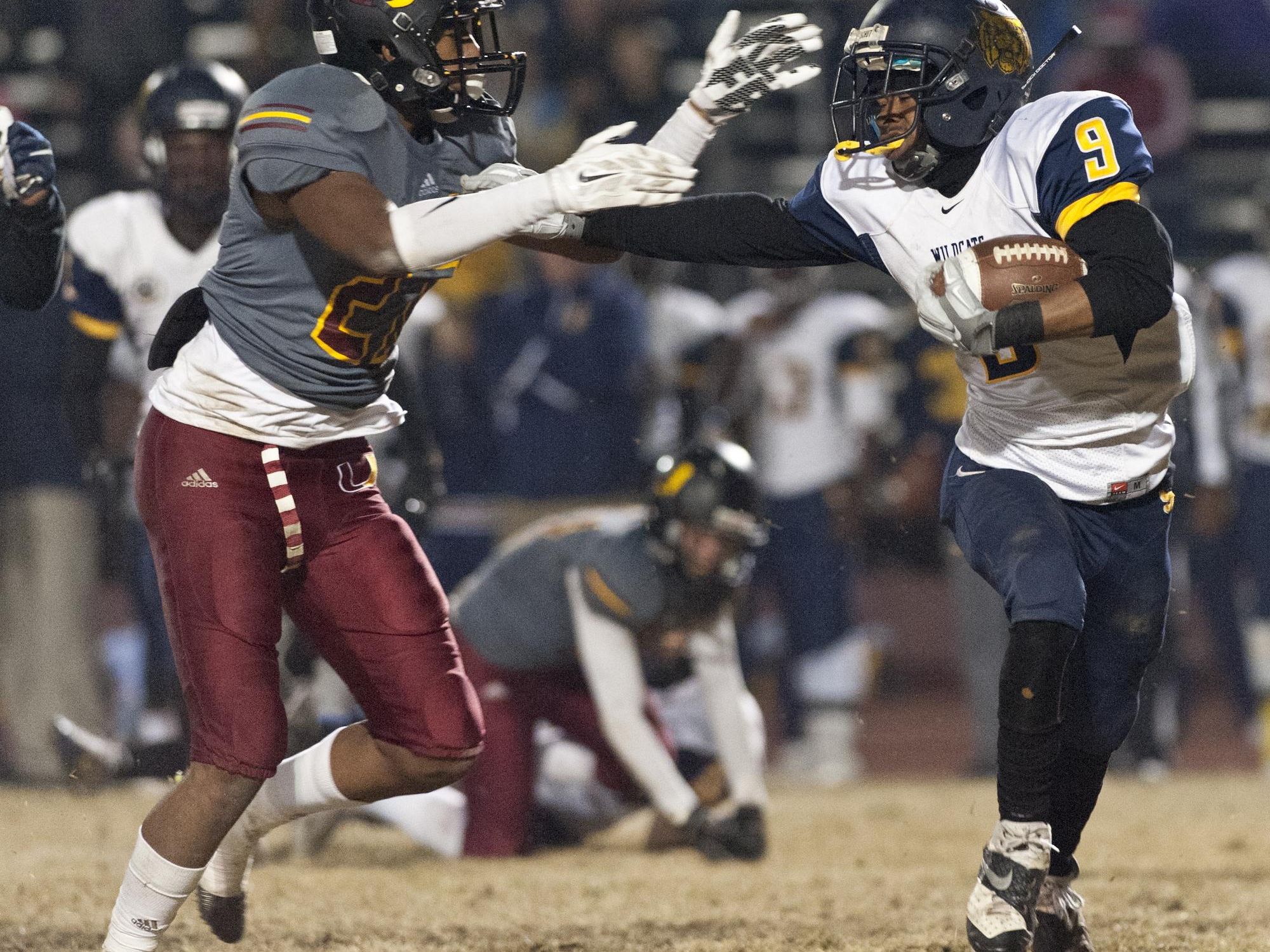 Sunnyside’s Aaron Mouton, right, gets by Tulare Union’s Xavier Alexander during Friday’s Central Section Division II quarterfinal game at Bob Mathias Stadium. Sunnyside won 46-14.