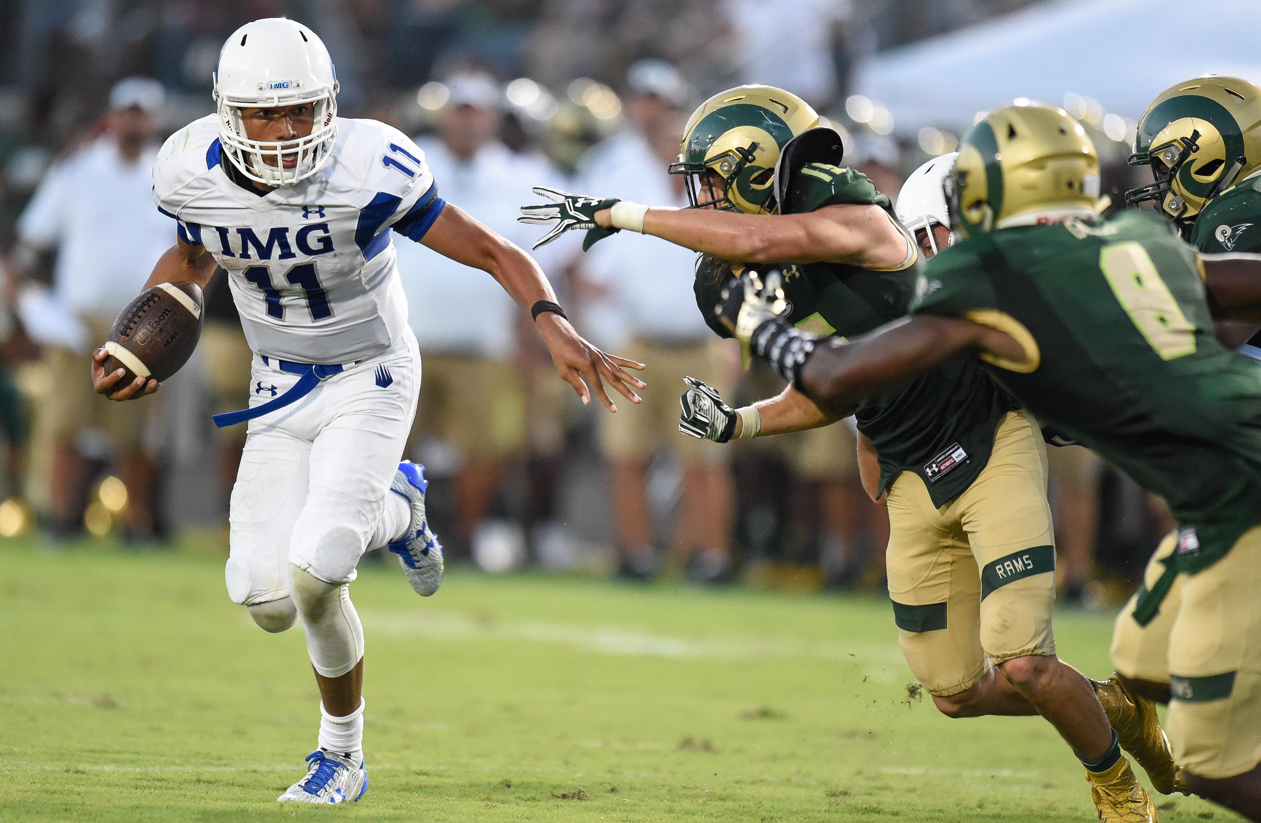 Aug 27, 2016; Loganville, GA, USA; IMG Academy quarterback Kellen Mond (11) runs against the Grayson Rams during the second half in a high school football duel of top ranked teams at Grayson Community Stadium. IMG Academy defeated the Grayson Rams 26-7. Mandatory Credit: Dale Zanine-USA TODAY Sports ORIG FILE ID: 20160827_sal_sz2_193.JPG