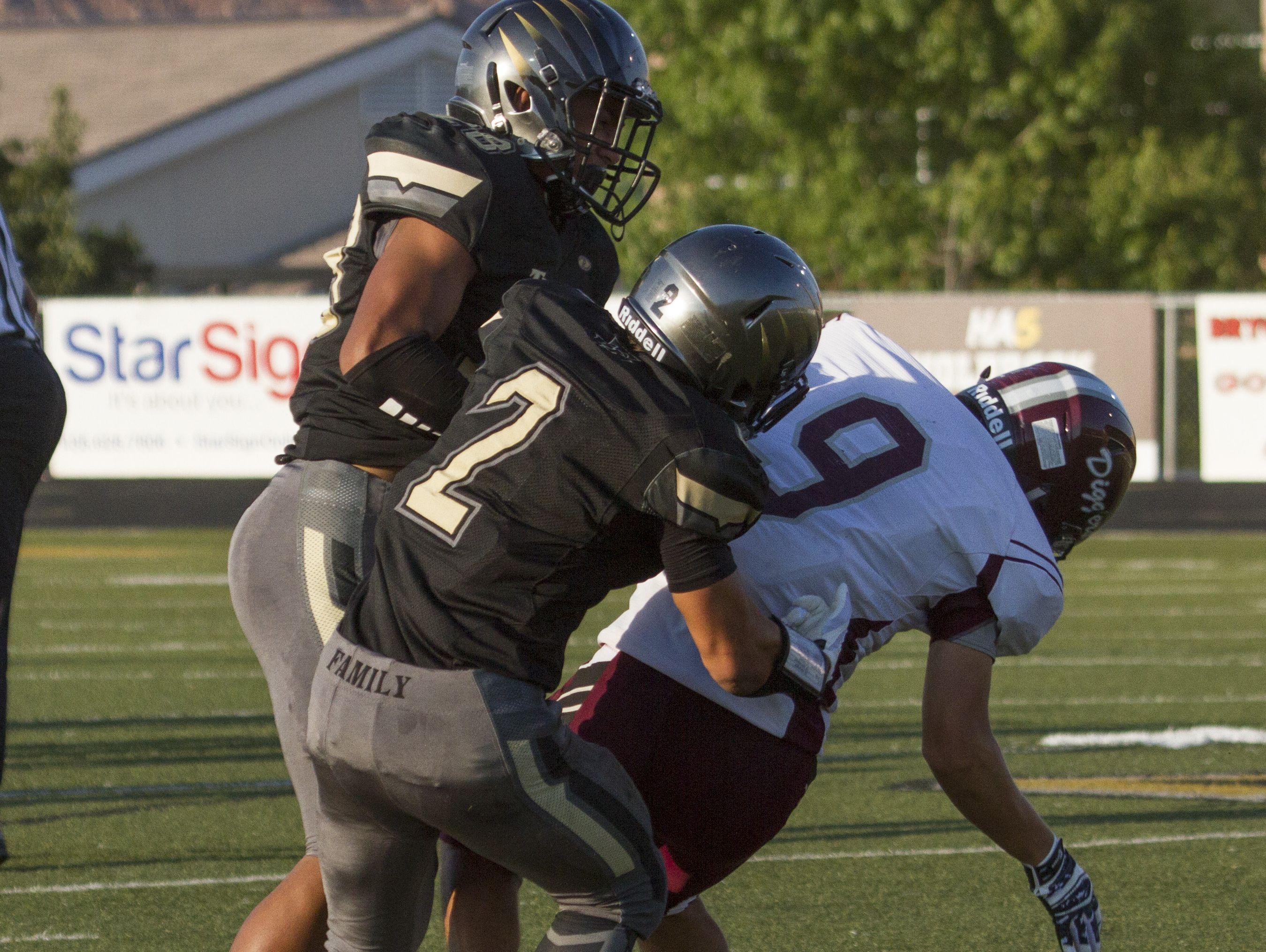 Desert Hills' Nephi Sewell hits a Jordan receiver during the first series of the game Friday, Aug. 21, 2015. The hit would be the season ending play for Sewell after damaging his vertebrae and needing emergency surgery.