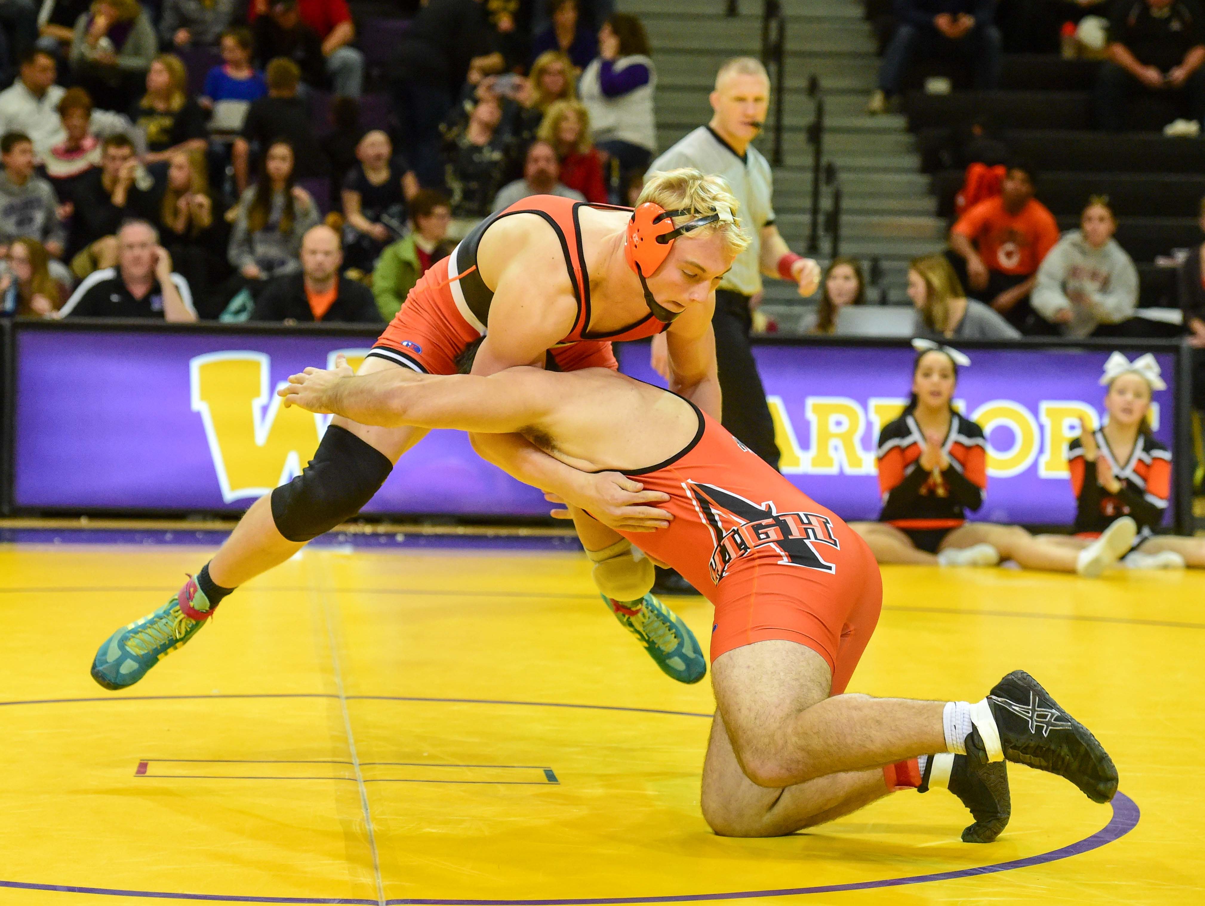 At 220lbs Valley's Rocky Lombardi sprawls as Ames' Harrison Townsend shoots in for a takedown on Thursday, December 10, 2015, during a wrestling meet held at Waukee High School.