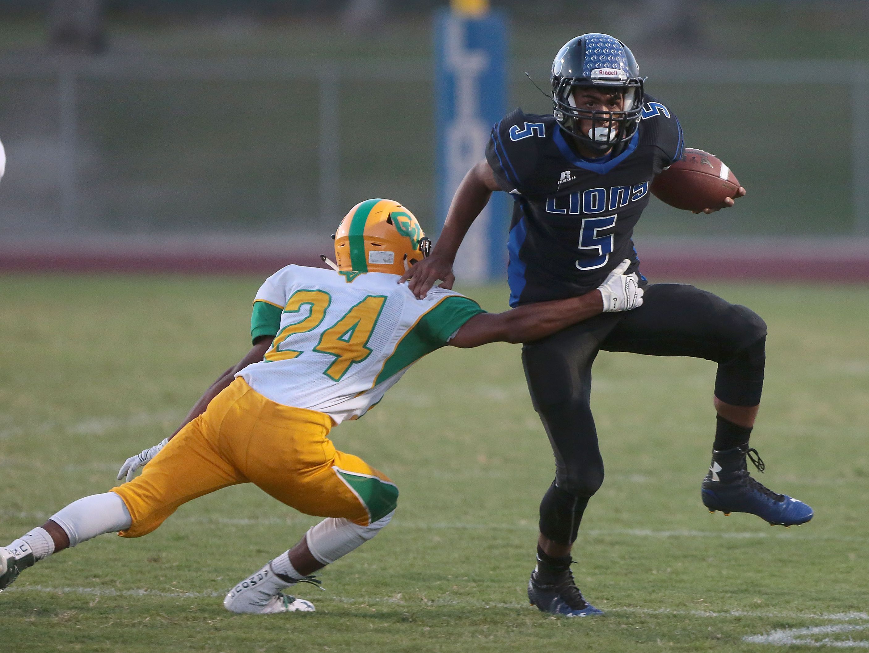 Cathedral City quarterback Jordan Wallace picks up yardage against Coachella Valley, August 26, 2016.