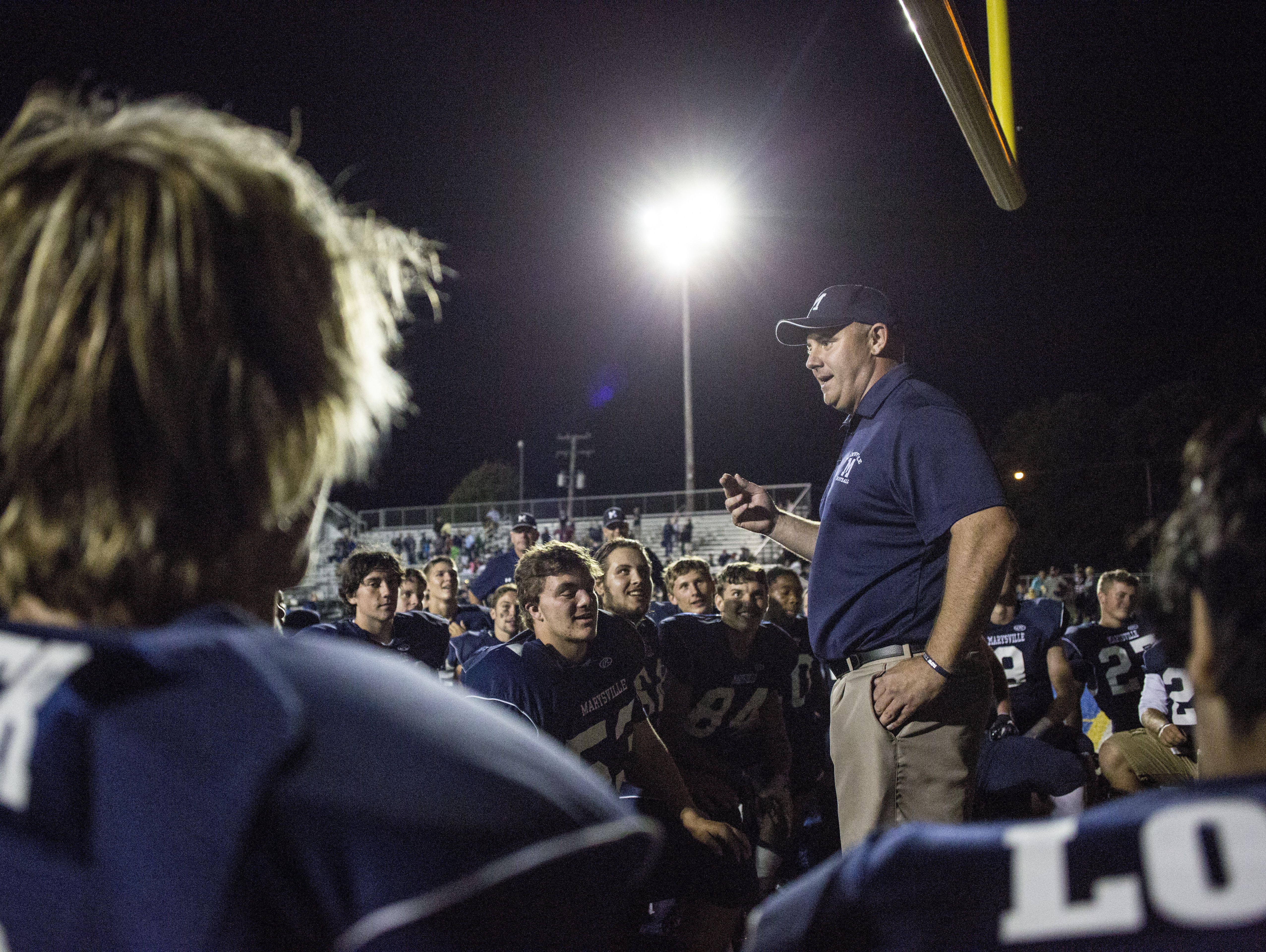 Marysville coach Mark Caza talks with players after beating Marine City in a football game Friday, September 16, 2016 at Marysville High School.