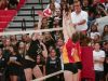 Two Palm Desert blockers rise up to try to stop a spike from the Xavier Prep player.