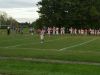 Junior-varsity football players from Fairport (in white) and Webster Schroeder stopped playing their game on Thursday night when they heard the national anthem before the start of the varsity boys soccer game on an adjacent field.