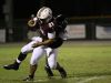 Riverdale running back Zachary Sanders is tackled by Gulf Coast's Reid Fermon during Friday night's district game at Riverdale.