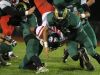 Regis defenders take down Kennedy's Bishop Mitchell as the Rams defeat the Trojans 15-7 in a Tri-River Conference game on Friday, Sept. 30, 2016, in Stayton.