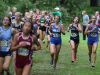 The Girls Seeded Class AA medium schools runners make their way through a wooded area on the last half of their race.