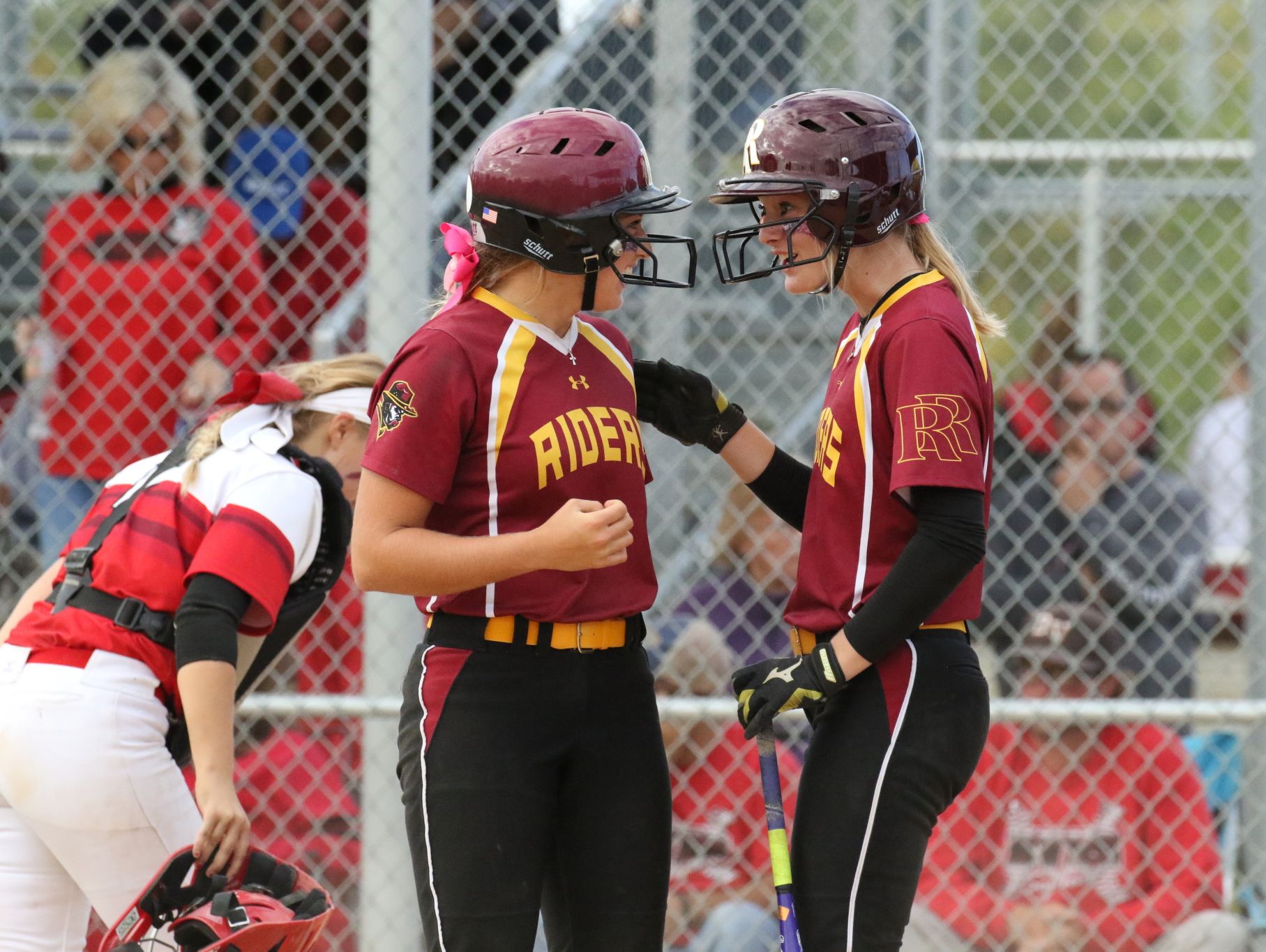 Roosevelt's Macy Schroedermeier (L) celebrates with Abby Schultz after scoring a run in the State Championship game against Brandon Valley at Sherman Park.