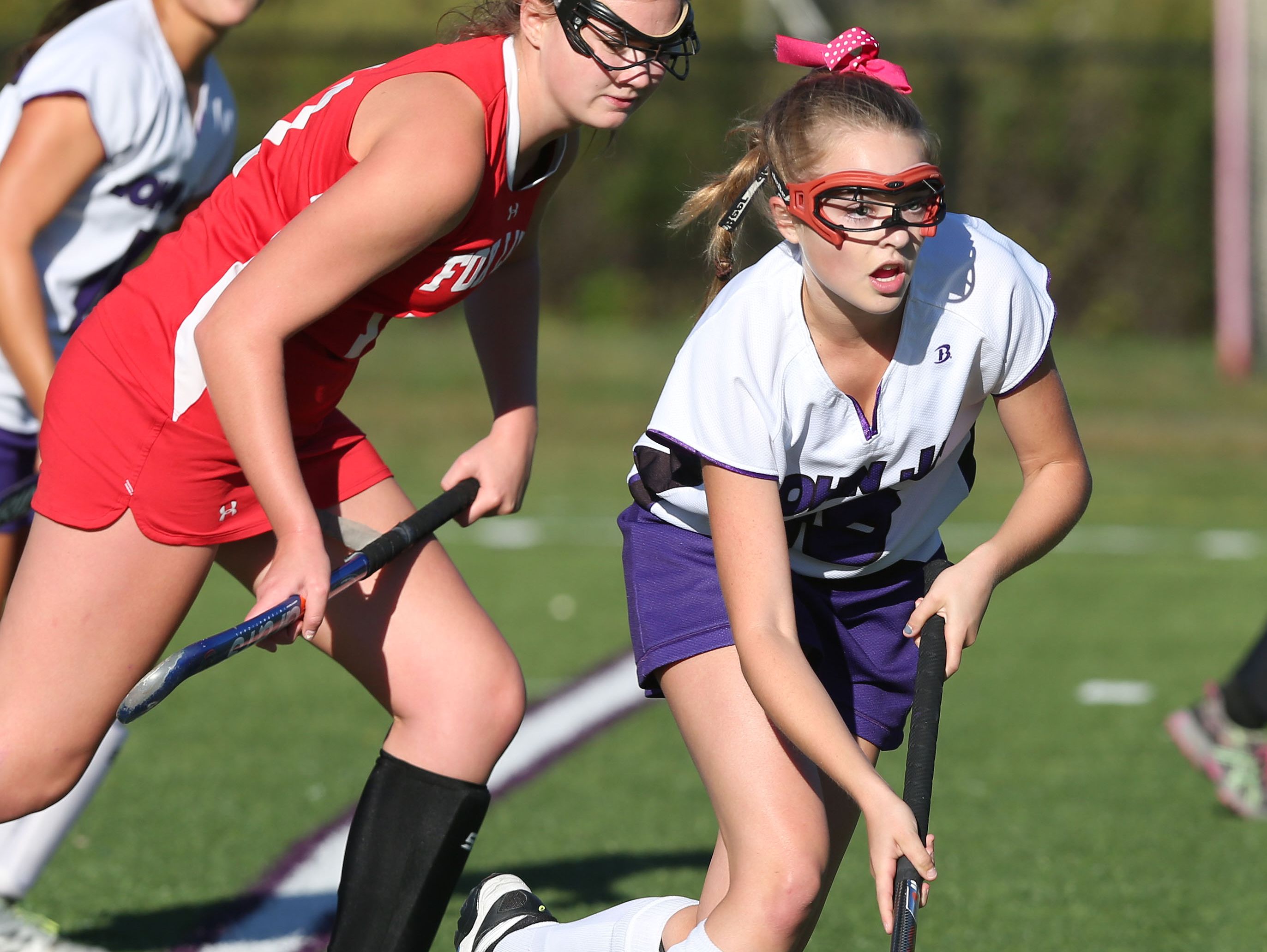 John Jay's Anna Prusko (18) moves the ball away from Fox Lane's Bridgit Connors (17) during field hockey game at John Jay High School in Cross River Oct. 6, 2016. The game ended in a 3-3 tie.