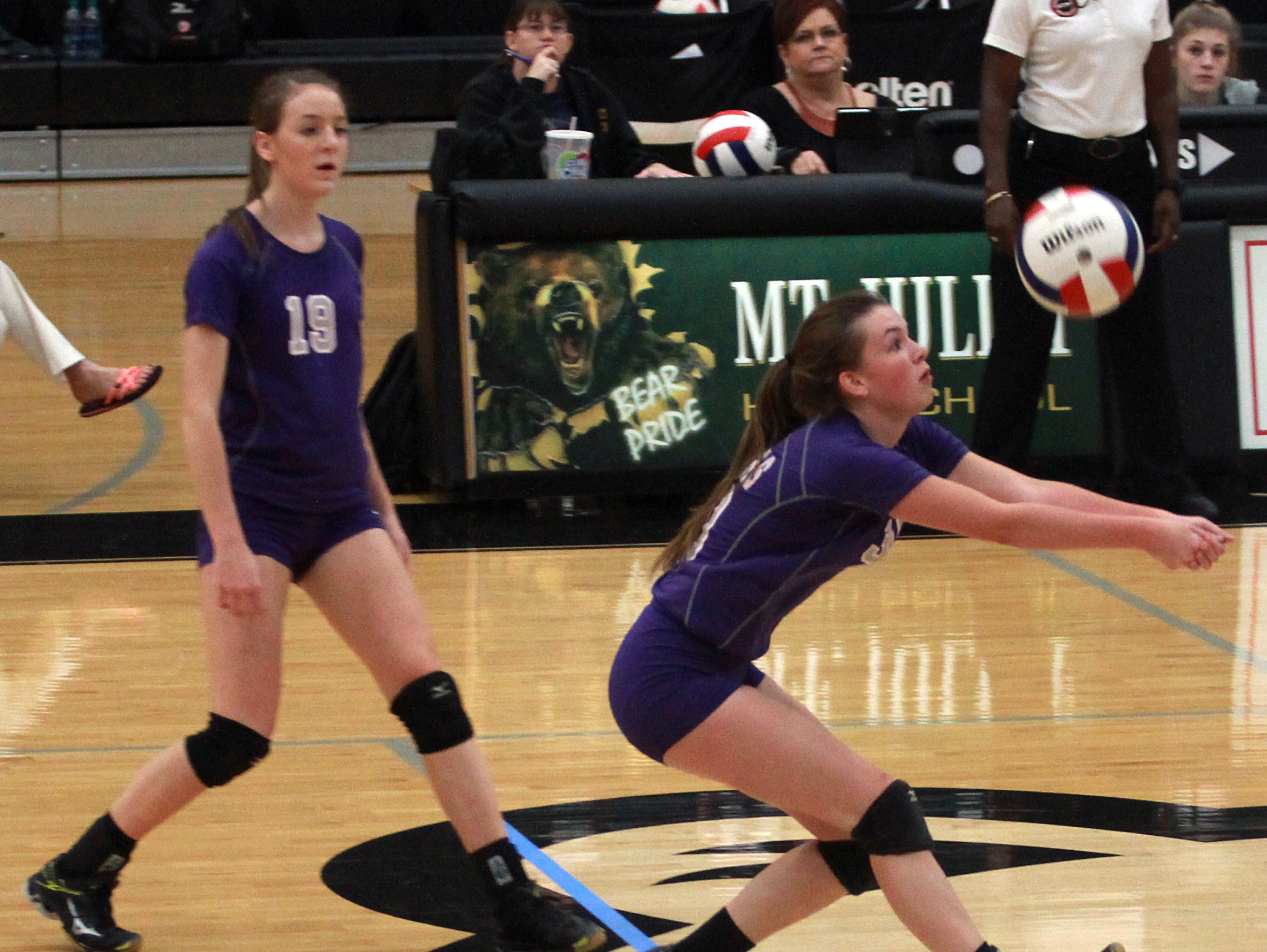 Portland's Katie Crutchfield sets the ball as teammate Marlayna Bullington watches during Thursday's District 9-AAA Tournament championship match.