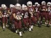 Assisted by teammates Dylan Foxhall (22) and Evan Allen (57), honorary football player Markus Baxley, a student with cerebral palsy, takes the field with the Tate High School team prior to the game against Pace High School in Pensacola on Friday, October 7, 2016.