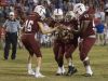 Jake Henry (16) hands off to honorary football player Markus Baxley(26), a student with cerebral palsy, as teammates Dylan Foxhall (22) and Evan Allen (57) carry him to a touchdown prior to the game against Pace High School in Pensacola on Friday, October 7, 2016.