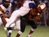 Palm Springs High School's Jeremy Dotson is taken down by Cathedral City High School's Jordan Wallace during their game at Palm Springs.