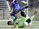 Goshen's Eryk Piasecki tumbles over Valhalla goalkeeper Lorenzo Luciano as Luciano makes the save during the Section 1 vs. Section 9 boys soccer challenge at Mamaroneck High School Oct. 10, 2016. Goshen defeated Valhalla 1-0 in overtime.