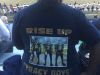 Laverna Tracy is wearing a T-shirt that has three words on the back: “Rise up Tracy boys!!!” Above those words is a picture of three Decatur Central players. No. 11, No. 12 and No. 13.