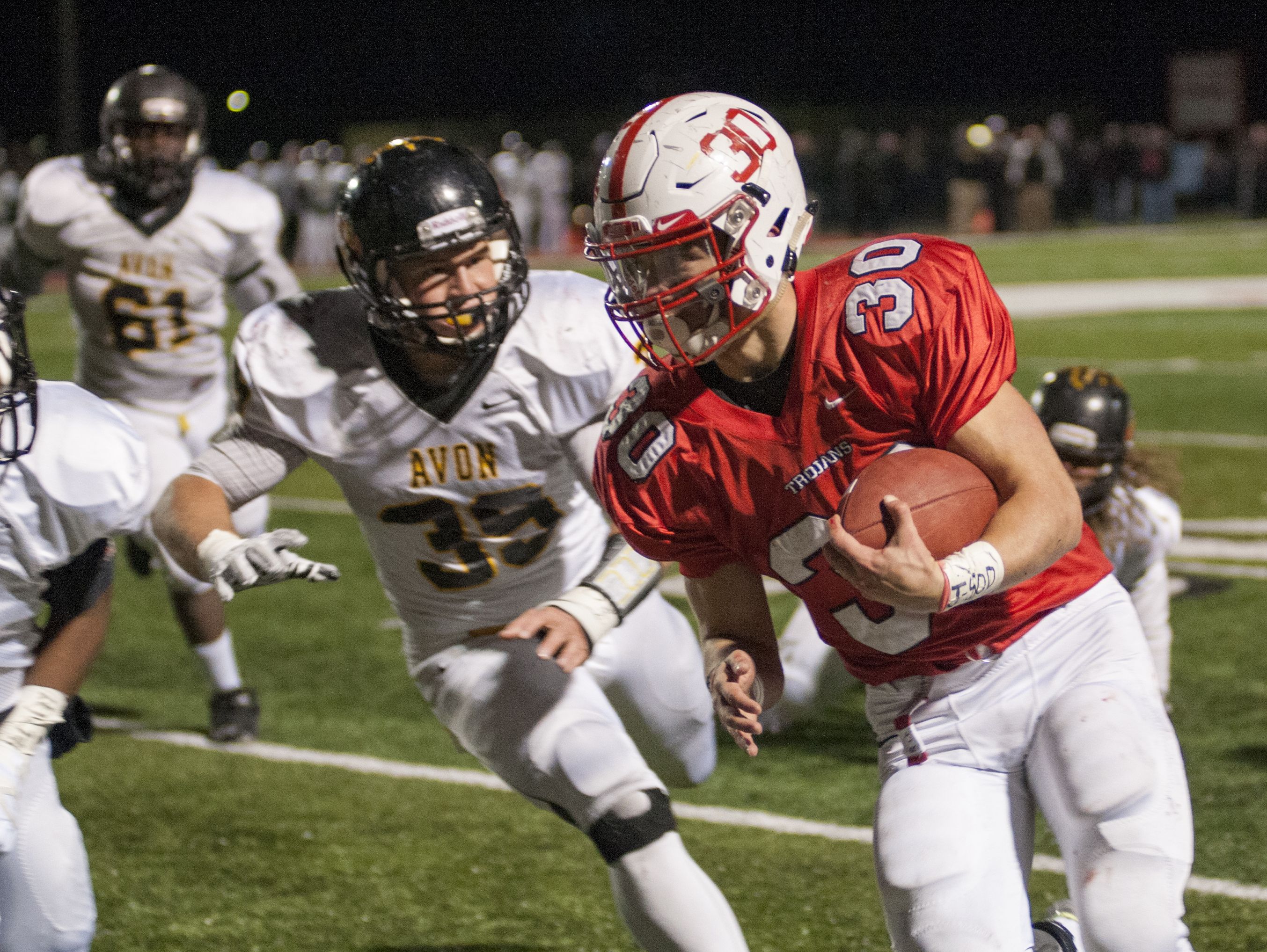 Center Grove's Titus McCoy (30) runs past Avon defense Friday, Nov. 13, 2015, during the Class 6A semi-state playoff game.