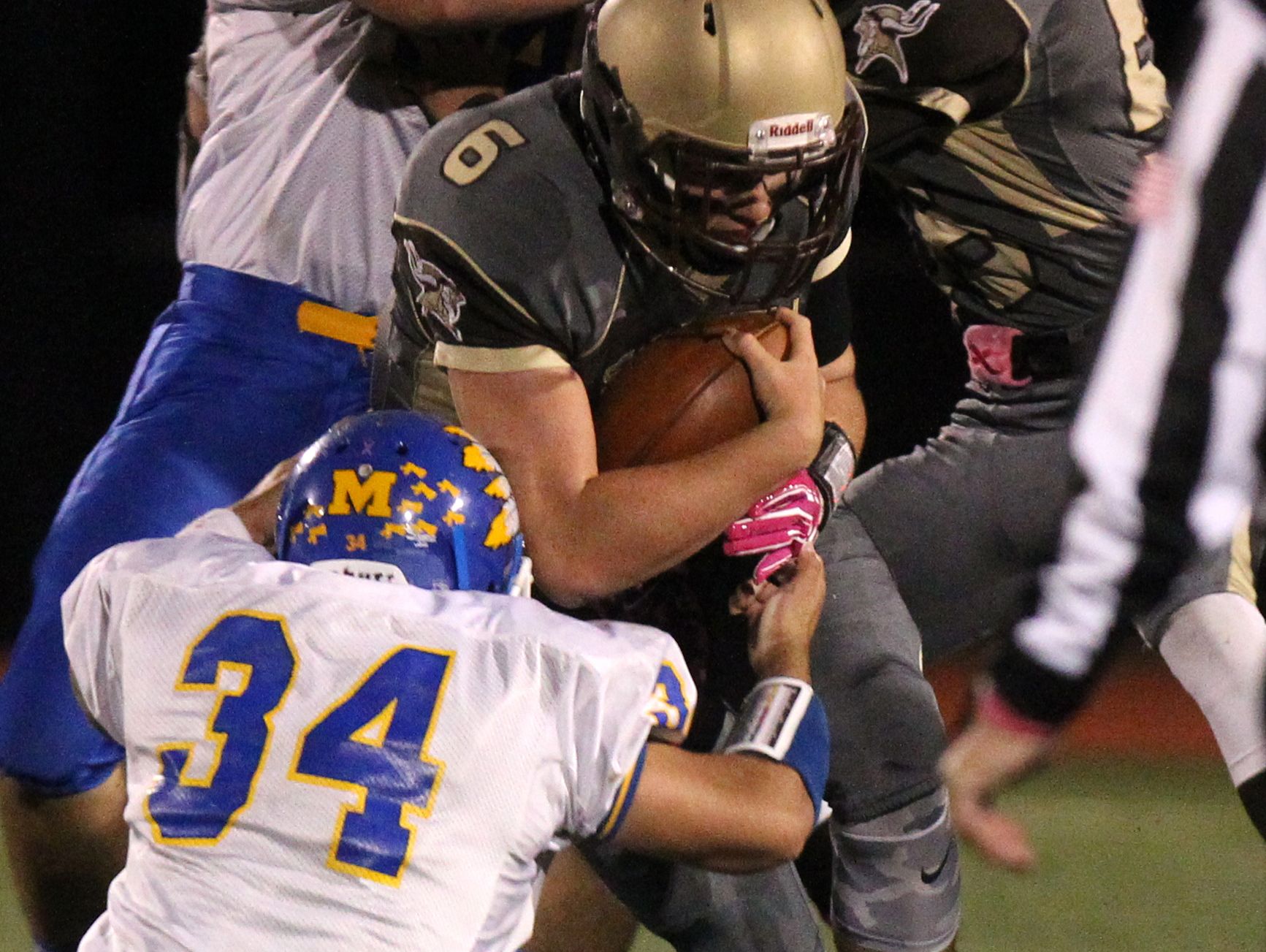 Clarkstown South's Matt Jung is tackled by Mahopac's Justin Munoz (34) during their Class AA playoff game at Clarkstown South Oct. 14, 2016.