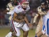 Pace quarterback, Damean Bivins, (No. 2) looks for a hole in the line of scrimmage after being forced out of the pocket by the Gulf Breeze defense during Friday night's District-2 6A game.