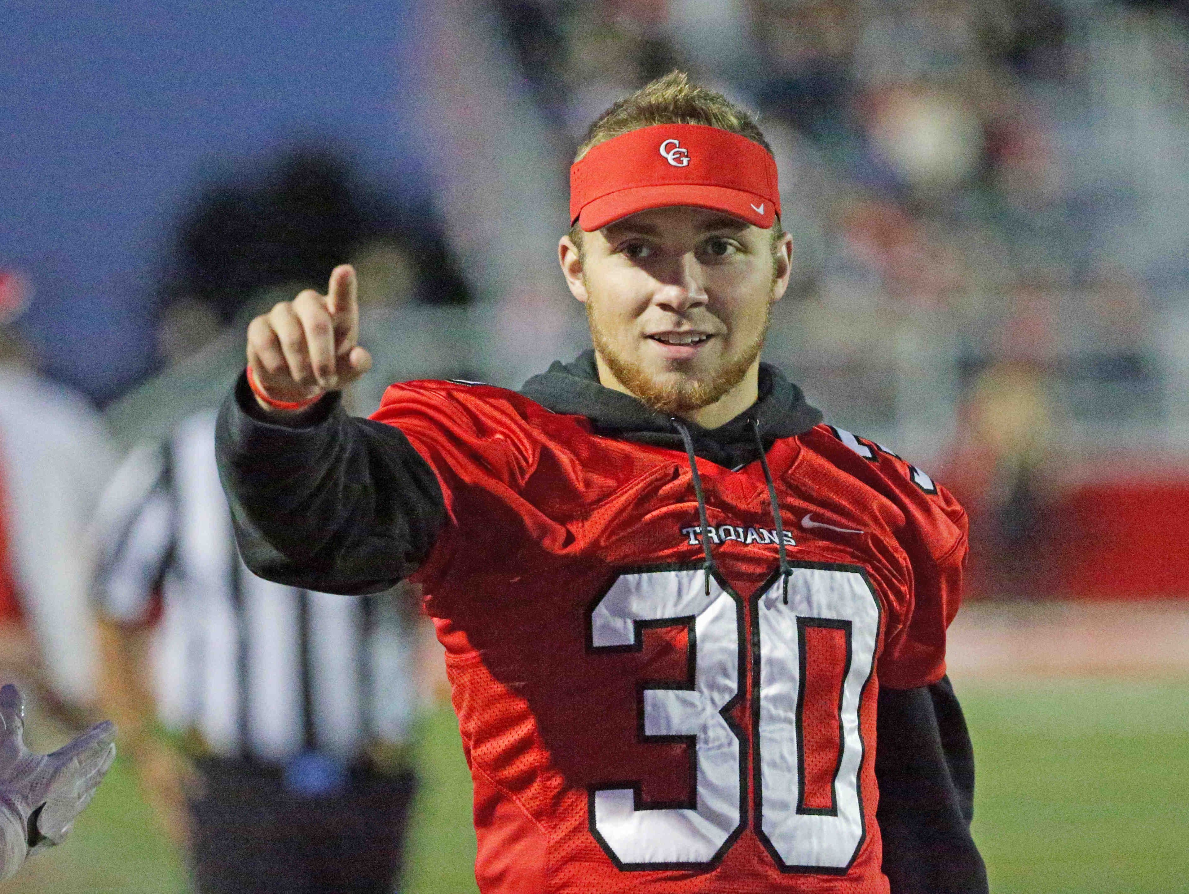 Center Grove's Titus McCoy cheers from the sideline during the Trojans' win over Cathedral on Friday.