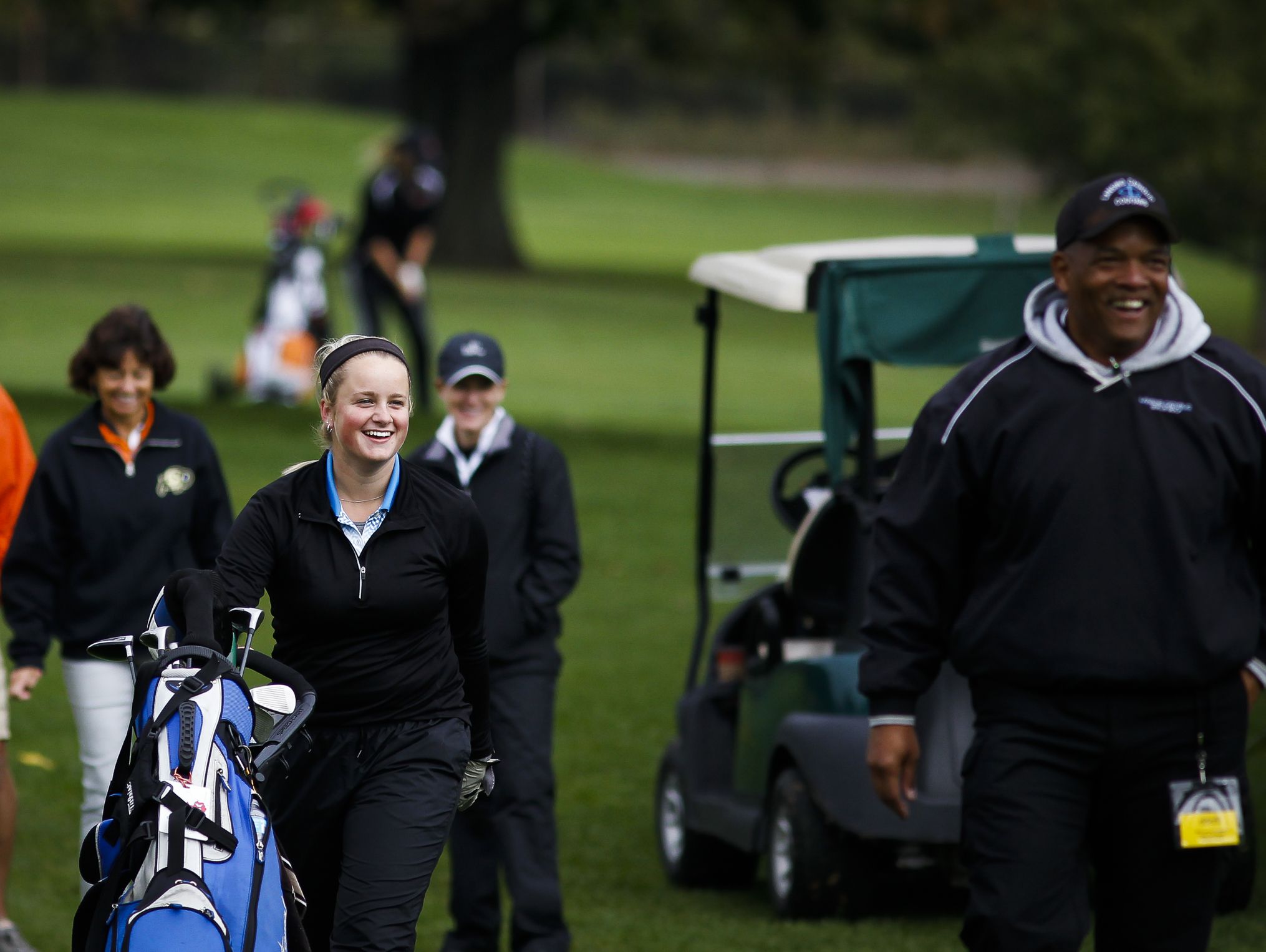 Lansing Catholic senior Abigail Meder and her coach Kim Johnson, right, smile after Meder eagled the fourth hole during the Div. 4 Girls Golf Finals October 15, 2016, at Forest Akers West at Michigan State University.
