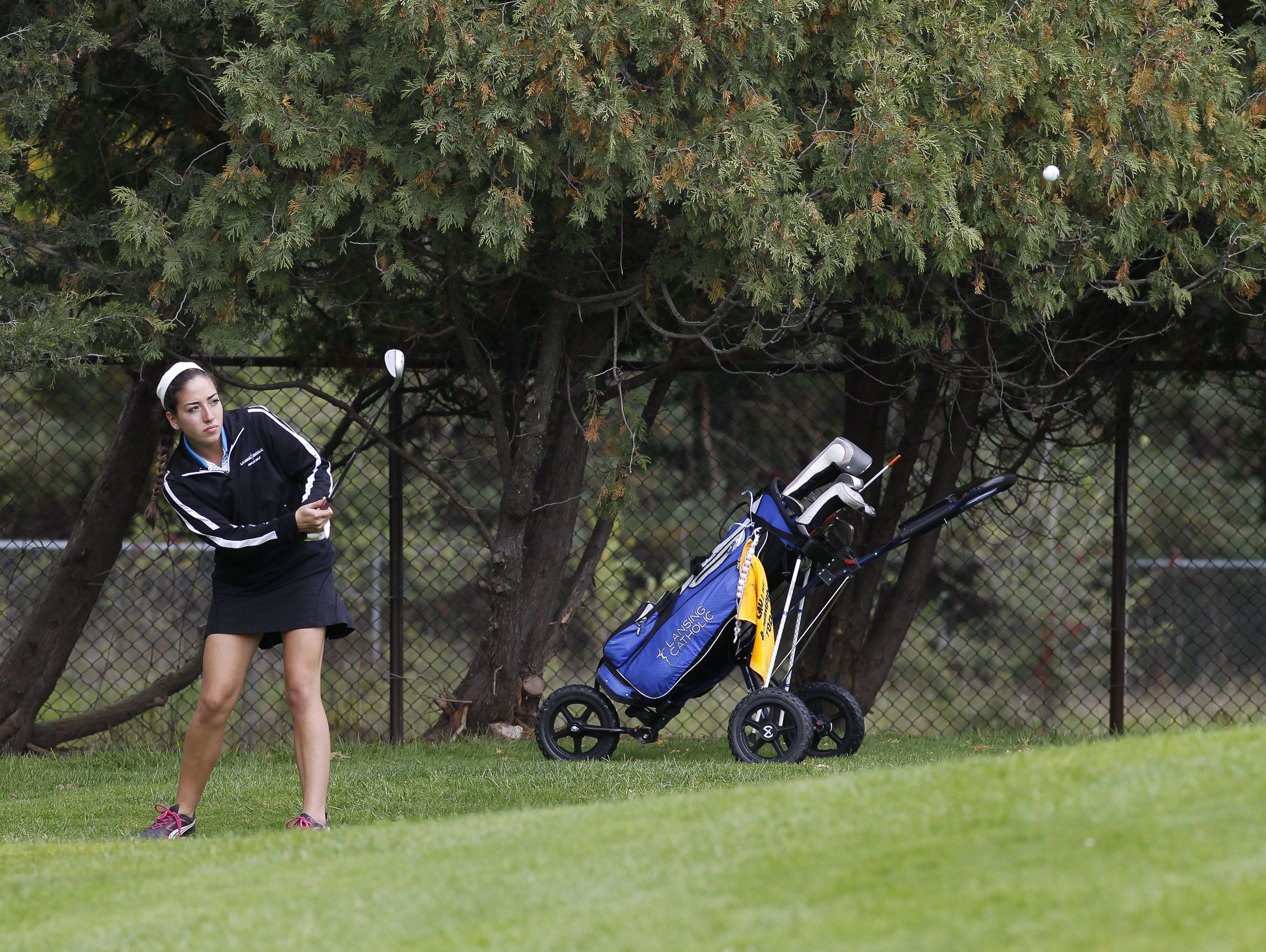 Lansing Catholic senior Alyssa Rodriguez chips her way onto the seventh green during the Div. 4 Girls Golf Finals October 15, 2016, at Forest Akers West at Michigan State University.