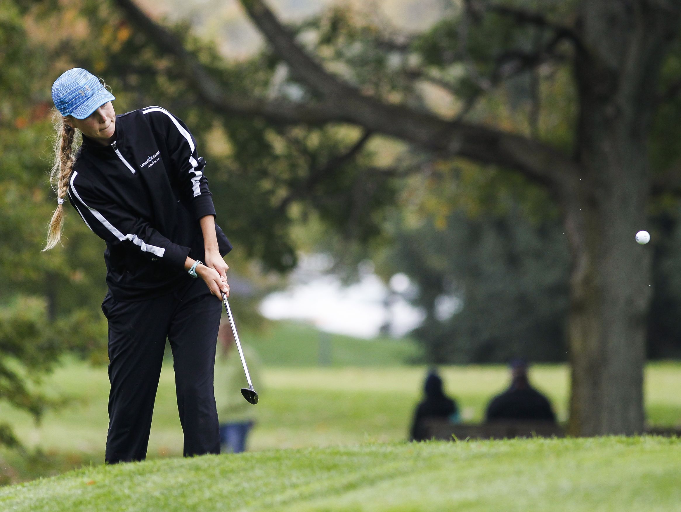 Grace Castle of Lansing Catholic chips her way onto the 18th green during the Div. 4 Girls Golf Finals October 15, 2016, at Forest Akers West at Michigan State University.