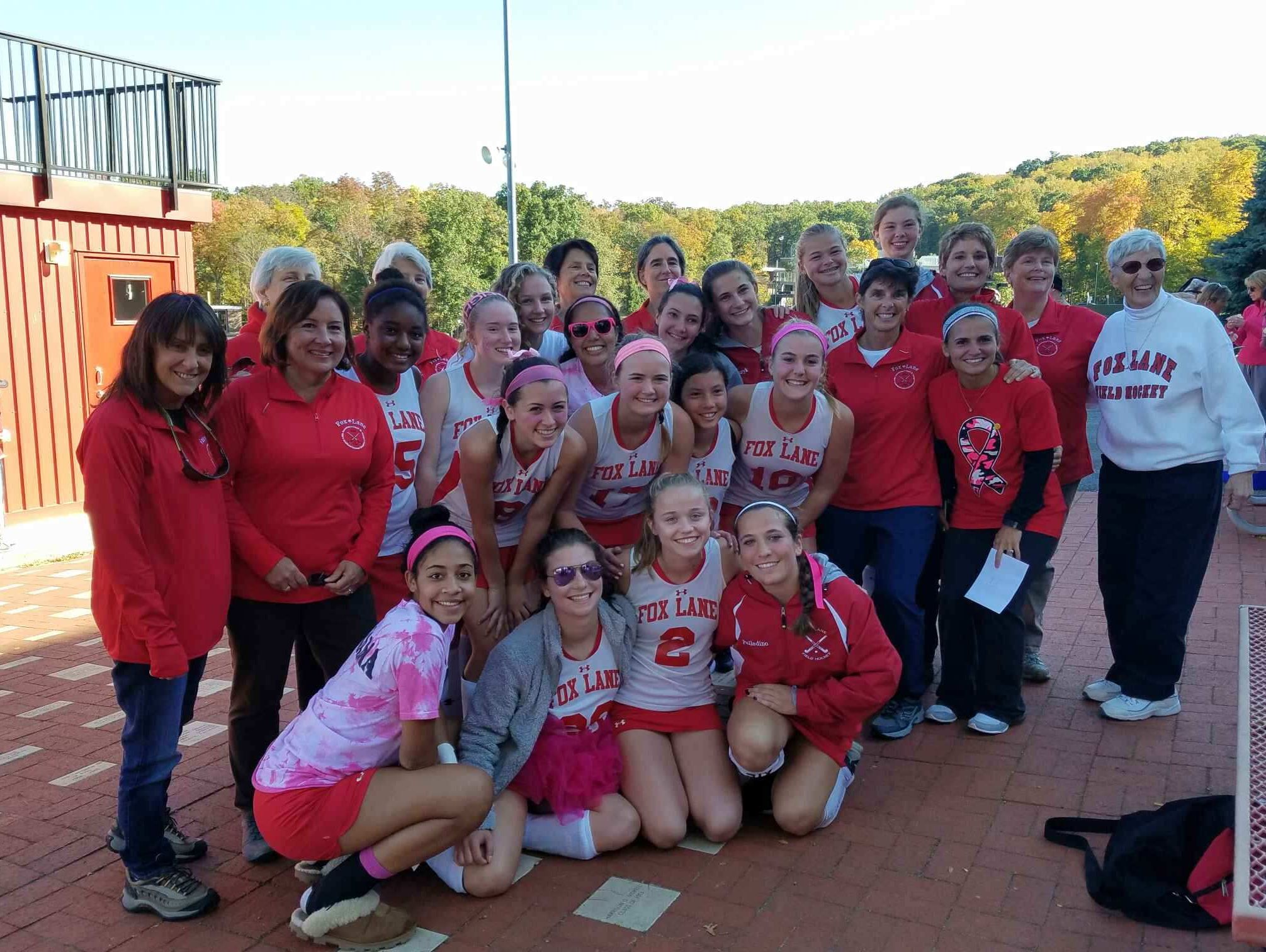 Joanne St. George (r), whose 1976 Fox Lane team went undefeated, with nine of those players and the current Fox Lane team.