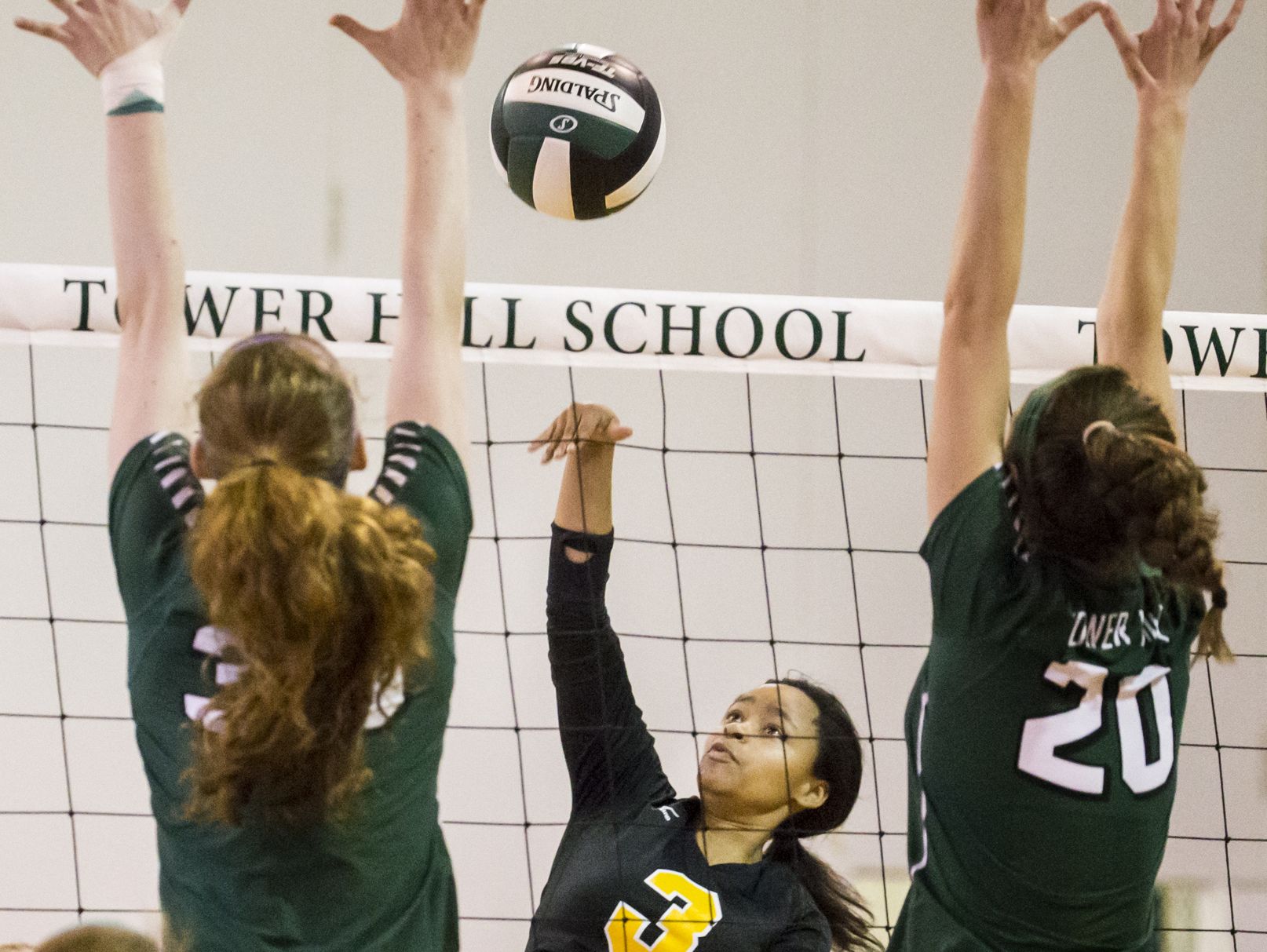 Tower Hill's Leslie Butler (No. 3) puts the ball over the net as Tower Hill's Josephine Thrasher (No. 38) and Marie Freebery (No. 20) leap for a block in the second game of Tower Hill's 3-0 win over Tatnall at Tower Hill School in Wilmington on Tuesday afternoon.