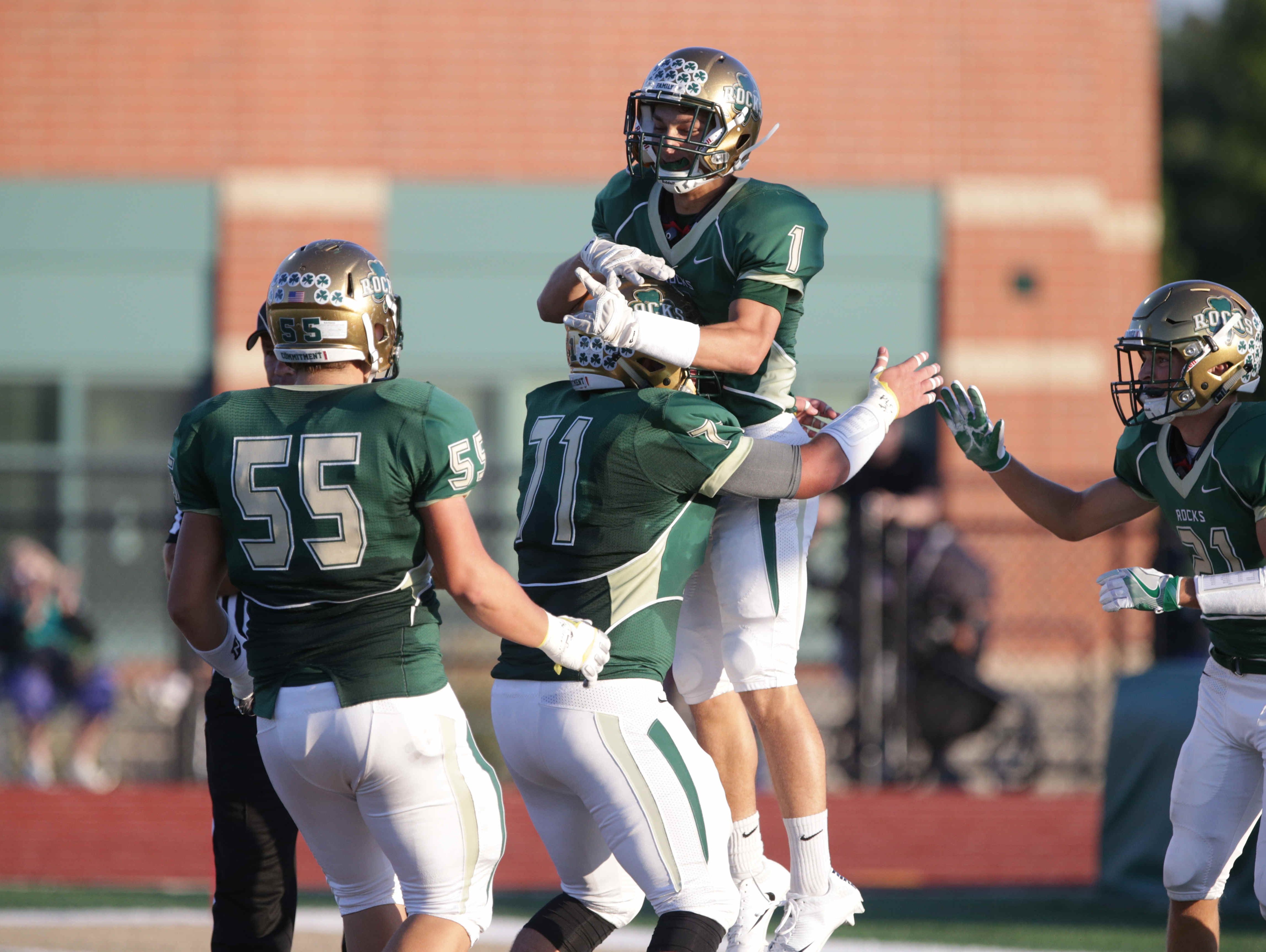Westfield's No. 1, Evan Manley, celebrates a touchdown with team mates No. 55, Matthwe Robinson, No. 71, Chad Reech, and No. 21, DrewNeustifter, Friday September 2nd, 2016. Westfiled faced off against Zionsville at Westfields's Riverview Health Stadium.