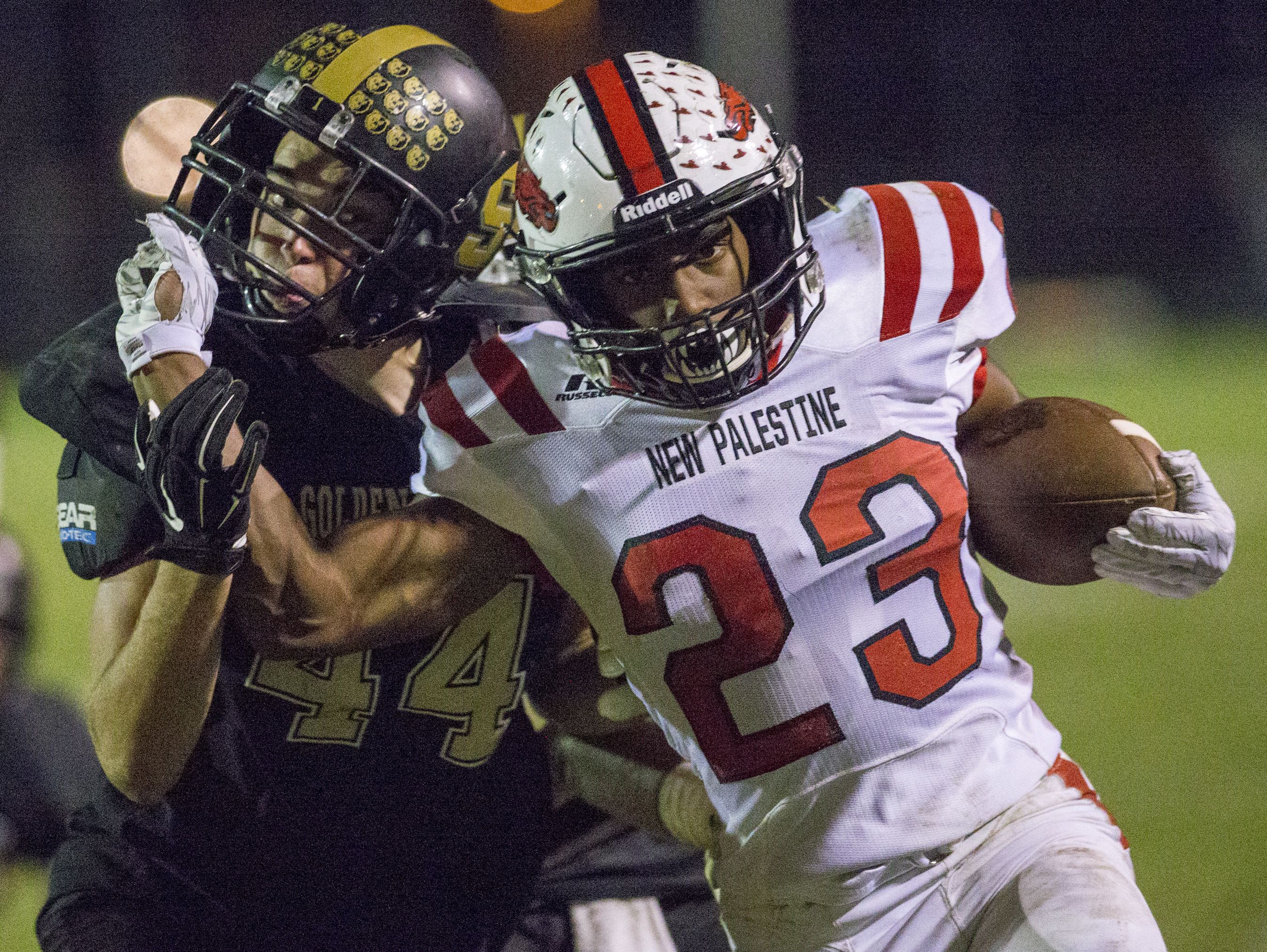DuRon Ford of New Palestine, tries to shed tackler Nathan Phillips of Shelbyville, during the third quarter, New Palestine High School at Shelbyville High School in a battle of unbeatens, Shelbyville, Friday, Sept. 30, 2016.
