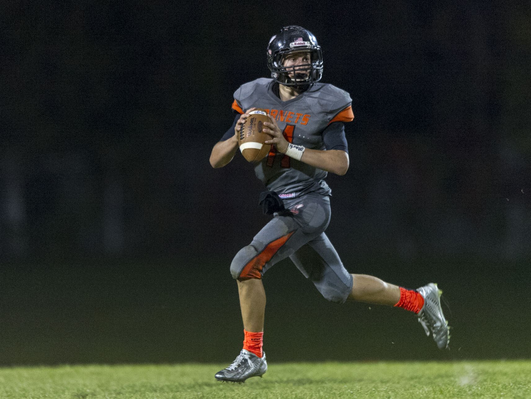 Beech Grove High School sophomore Chase Andries (11) is forced out of the pocket by the Monrovia defense, throwing an interception on this play during the second half of action. Beech Grove High School hosted Monrovia High School in varsity football action, Friday, September 26, 2014. Beech Grove held on to a 48-44 victory as time expired.