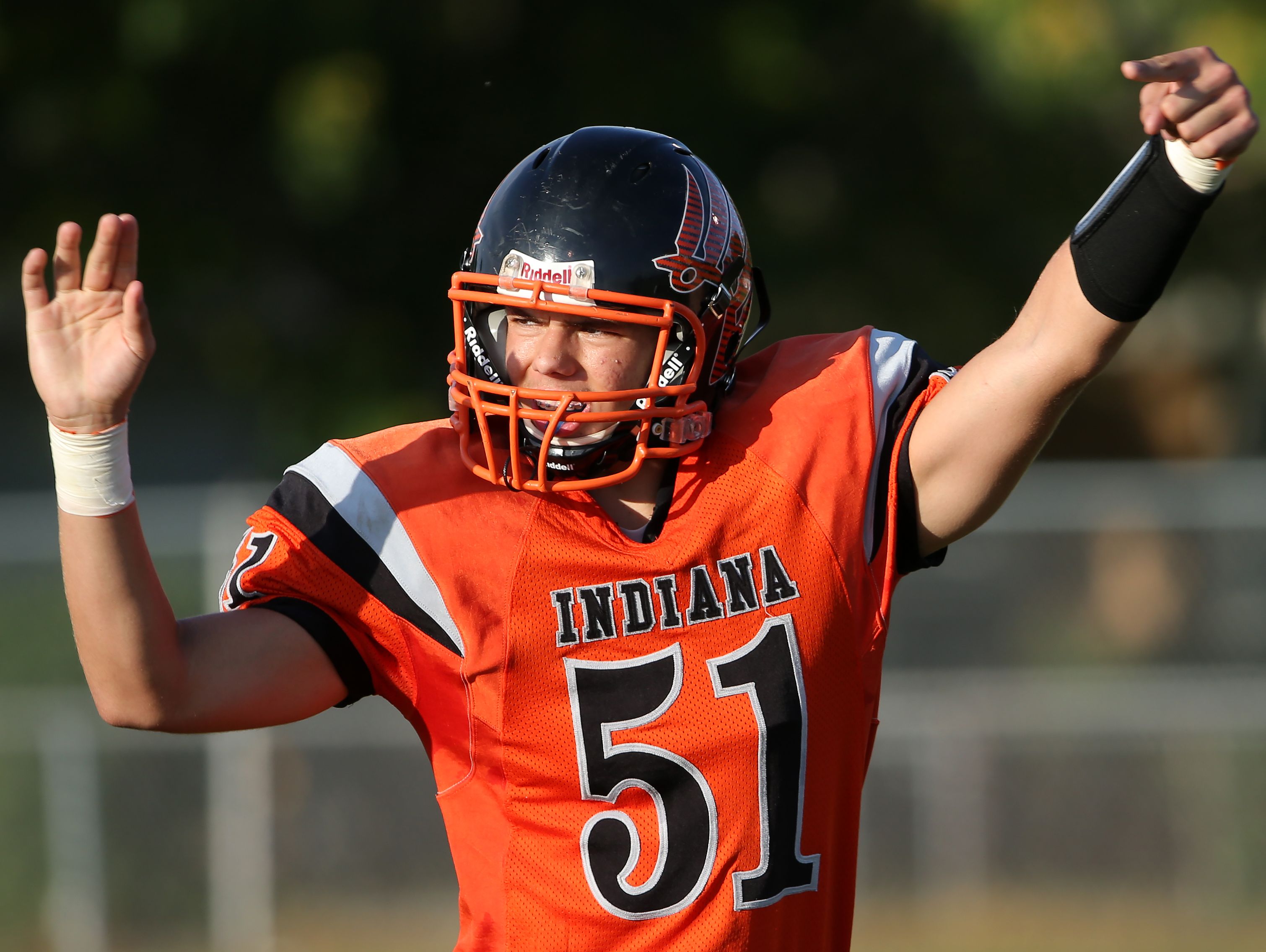 Indiana School for the Deaf linebacker Lance Wood calls out a play against Traders Point Christian Academy, on Friday, August 22, 2014, the opening night of high school football in Indianapolis.
