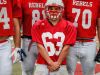Roncalli Rebels nose tackle Max Quebe, a 5-foot-2-inch, 135-pound Russian adoptee, poses for a portrait alongside some of his fellow teammates during practice on Oct. 19, 2016.