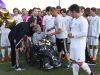 Fort Collins High School head coach Justin Stephens hands a rose to Heather Keaten before a soccer game on Thursday, October 20, 2016. Keaten, mother of player Mathew Keaten, has stage IV brain cancer and the team sold t-shirts and collected donations at the game to raise money for her care.