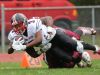 William Penn's Joe Greenwood dives for extra yardage while being tackled by Concord's Byron Simpson in the first quarter of the Colonial's 14-7 win over Concord.