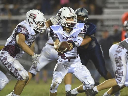 Scarsdale's Barry Klein hands off to Nick Leone during Friday's game against John Jay High School.