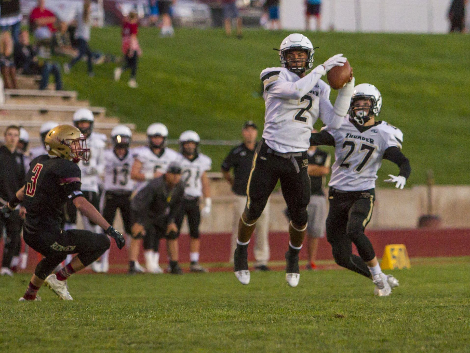Desert Hills' Nephi Sewell makes an interception and returned it for a touchdown in a game against Cedar earlier this season.