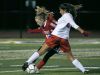 Fairport's Emily Racaniello and Penfield's Jordan Egger battle for the ball in the first half at Pittsford Sutherland High School. Penfield won 3-2.