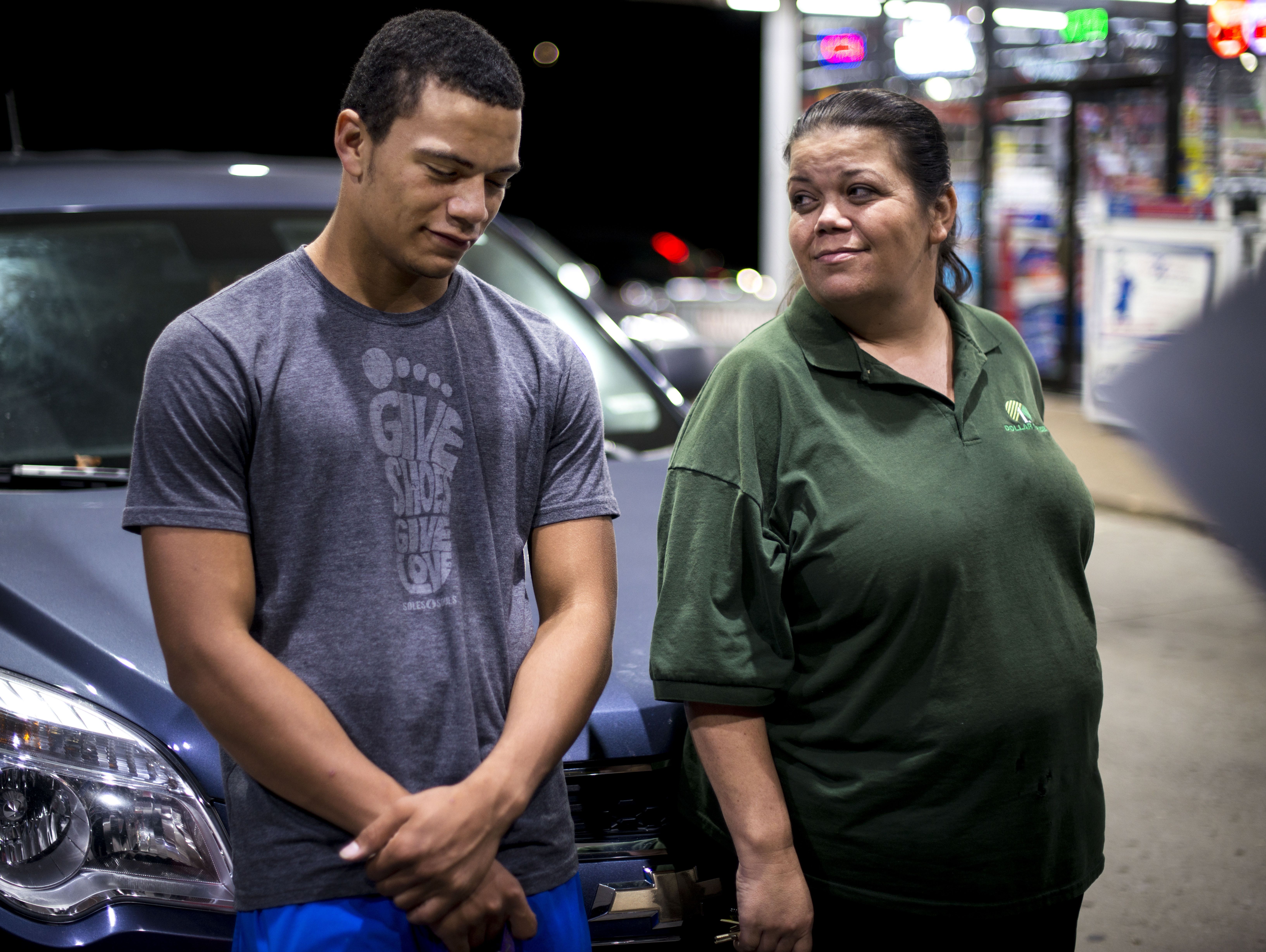 Shawn Murphy speaks with his mother Kim Murphy, who came to pick him up from a gas station after his car broke down on his way home from football practice, Tuesday, Oct. 25, 2016, in Nashville, Tenn.