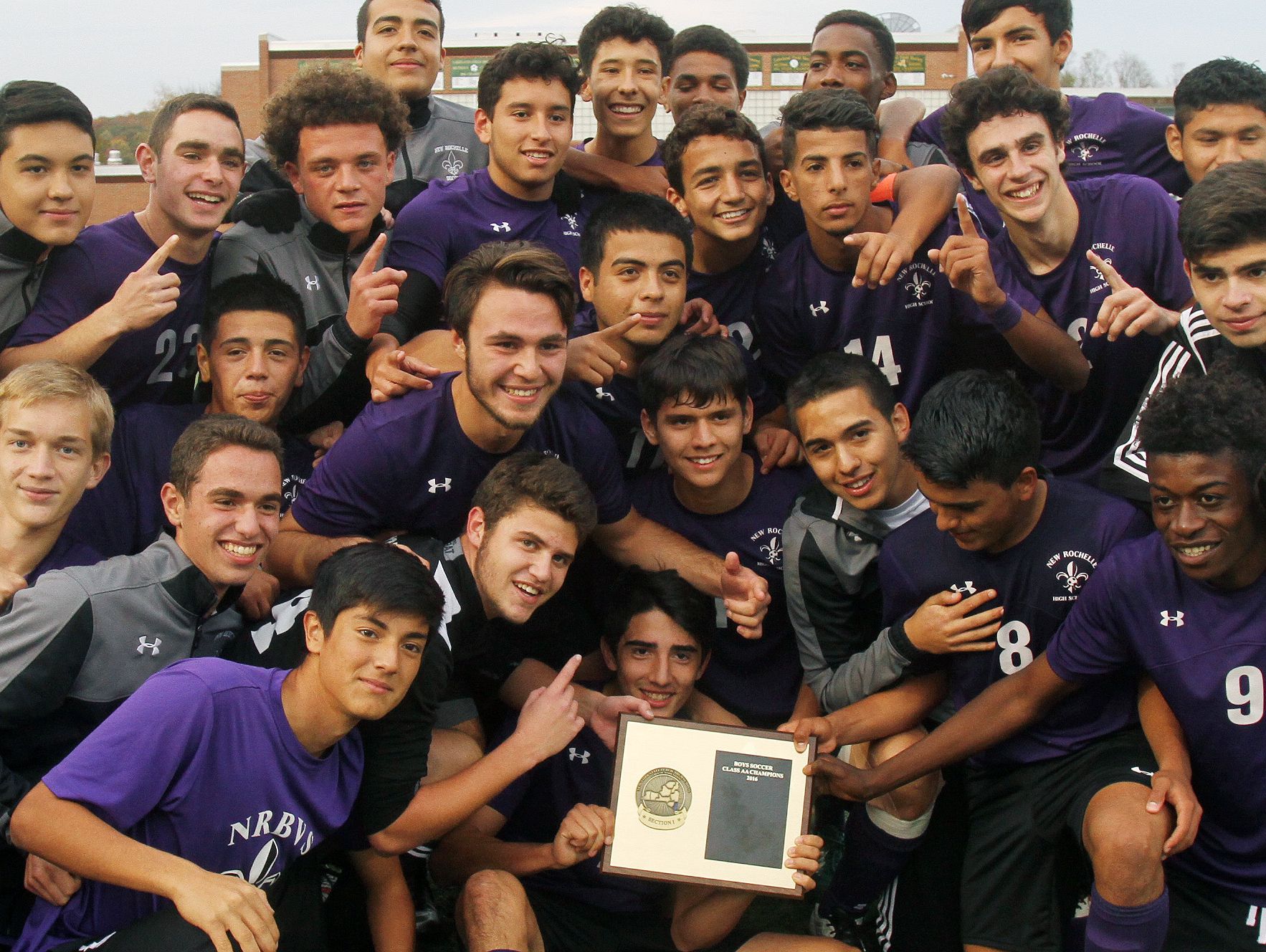 New Rochelle payers celebrate with the section 1 plaque after defeatingd Arlington 3-0 in the boys soccer Section 1 Class AA championship game at Lakeland High School in Shrub Oak High School Oct. 29, 2016.
