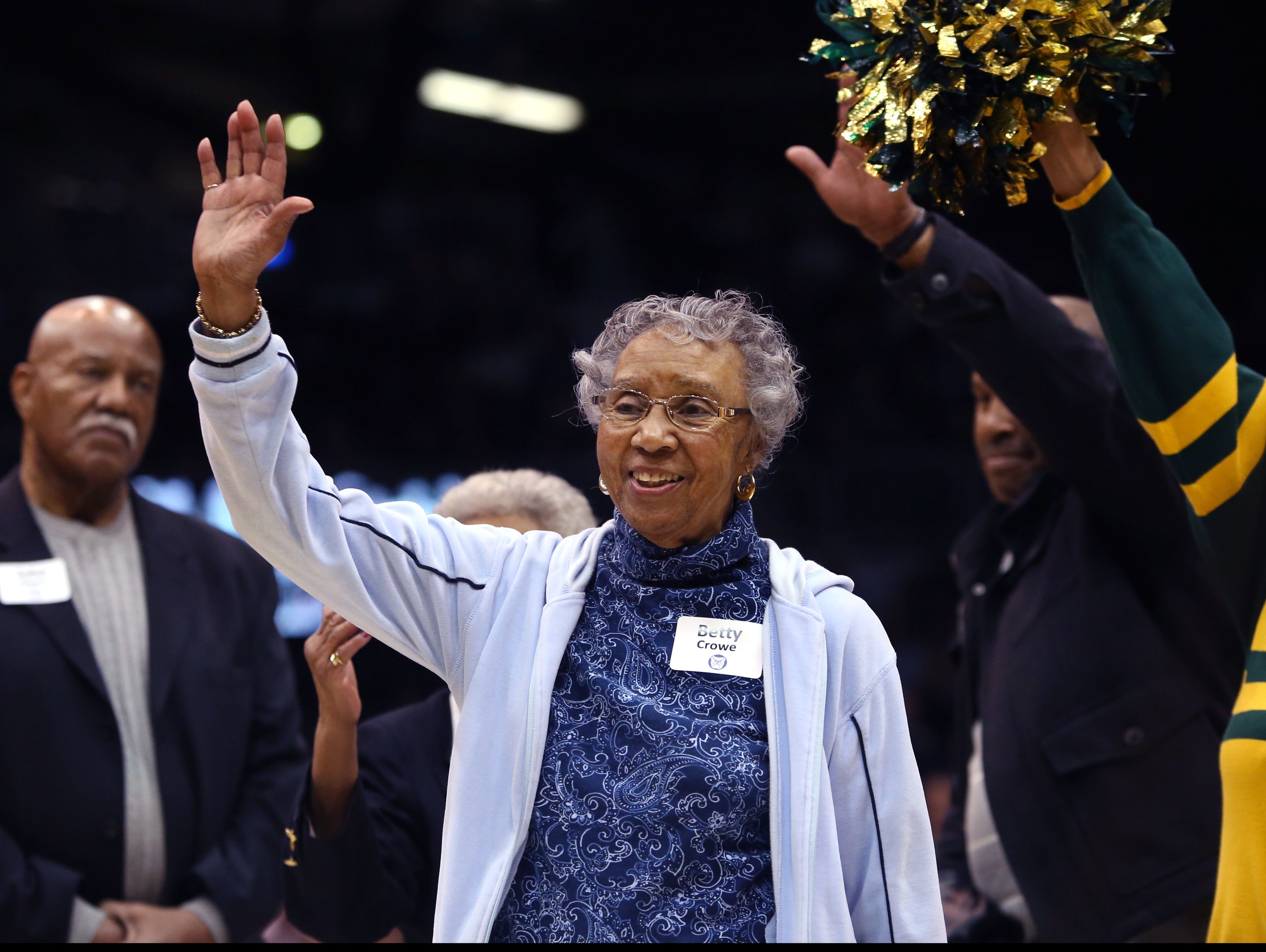Betty Crowe, widow of Ray Crowe, the coach of the 1955-56 Crispus Attucks High School teams that won the Indiana state high school basketball championships, is introduced during a 60th anniversary tribute to the teams during a time out at the Butler-Marquette game at Hinkle Fieldhouse in Indianapolis on Wednesday, Feb. 25, 2015.