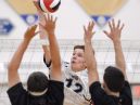 Webster's Justin Spiegel hits over the block of Hilton's Joe Hoover and Bryce Thompson.