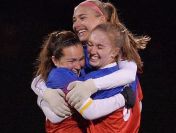 Fairport’s Claire Ritzmann, top, Emily McNally and Allison Donovan celebrate the Red Raiders goal.