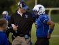 Cros-Lex coach Garrett Grundman talks with Justin Johnston during a football game.